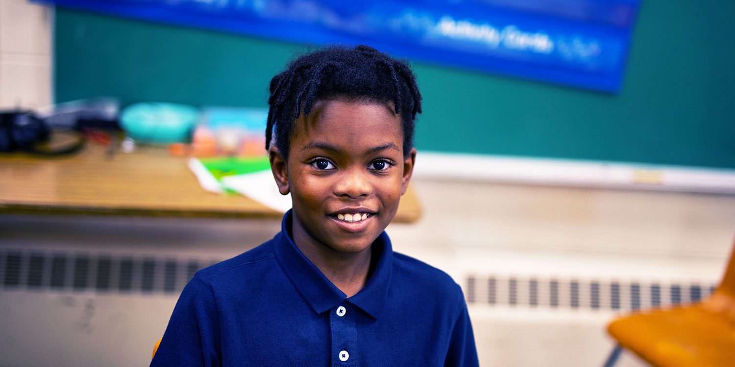Smiling student at desk.