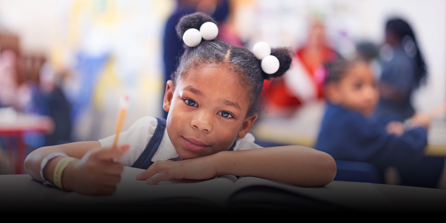 Student smiling in a classroom