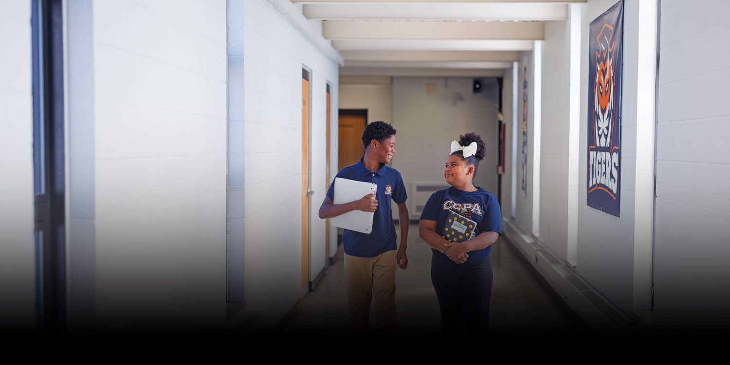 Smiling students in the hallway