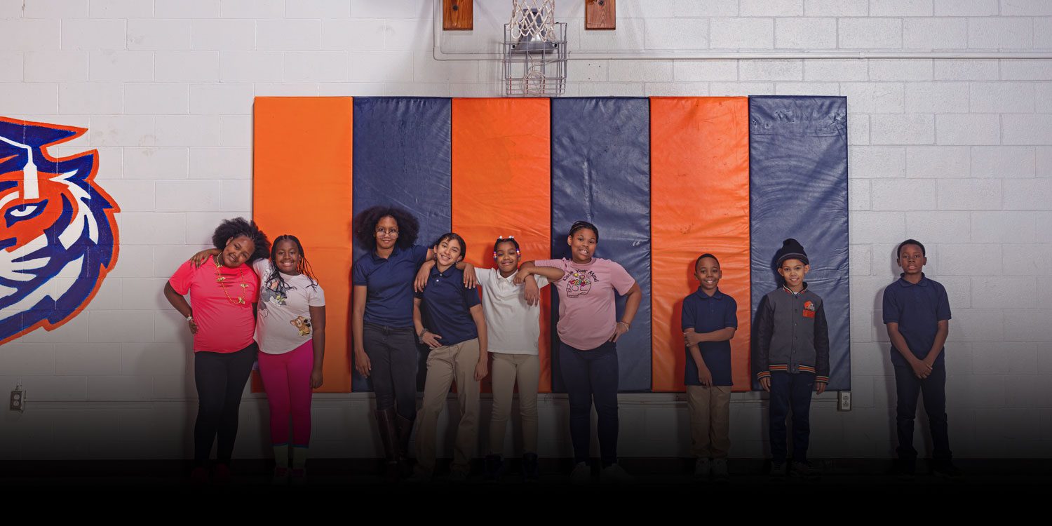 A group of smiling students at gymnasium
